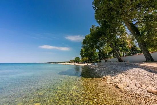 Fažana - oblázková pláž s pozvolným vstupem do moře.