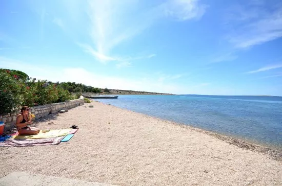 Oblázková pláž přímo před objektem.