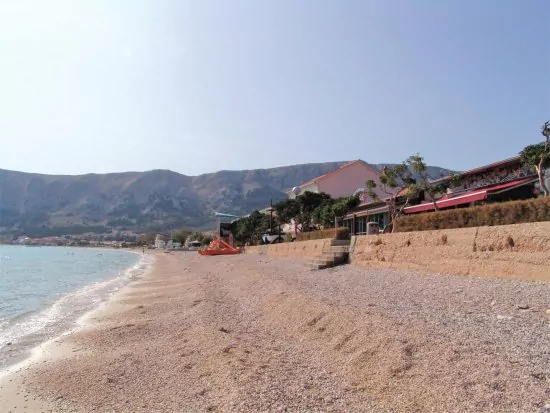 Baška oblázková pláž s pozvolným vstupem do moře.